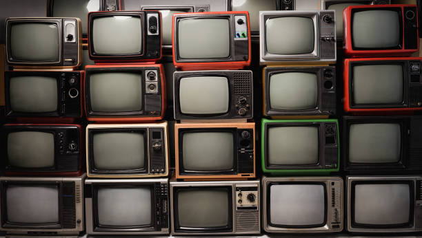 istock Old retro televisions pile and blank screen display. Many old TVs piled together on floor in the room, vintage filter style 1461067315