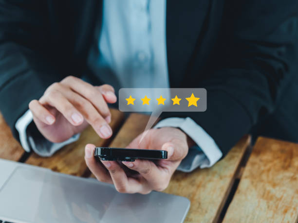 istock Customer review, satisfaction, feedback, survey concepts. The User giving 5 points or five stars rating to service experience, business ranking on mobile smart mobile phone in businessperson's hands. 1461069160