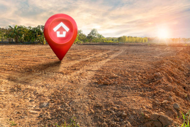 istock House symbol with location pin and Empty dry cracked swamp reclamation soil, land plot for housing construction project with and beautiful sunset sky with fresh air Land for sales landscape concept 1461069320