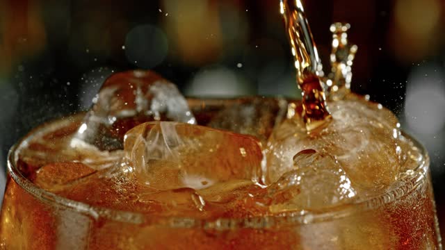 Super slow motion of pouring cola into glass with speed motion.