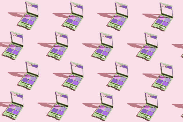 istock Creative pattern made of eye shadow palettes on pastel pink background. Beauty and make up concept. Minimal style. 1461074764