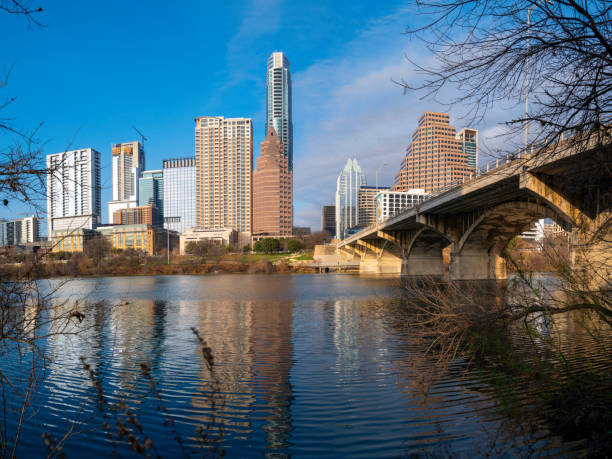 Vibrant Austin Texas city panoramic skyline behind trees, modern buildings, reflections on the Lady Bird Lake