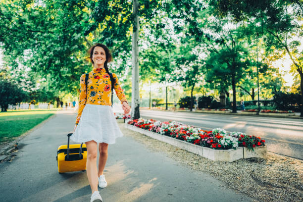 Woman with suitcase just arriving in Budapest and walking through Hero’s square