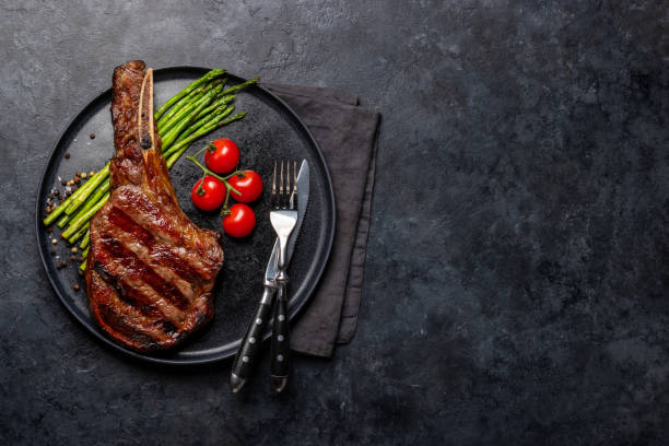 istock Medium rare grilled Tomahawk beef steak with asparagus 1461076237