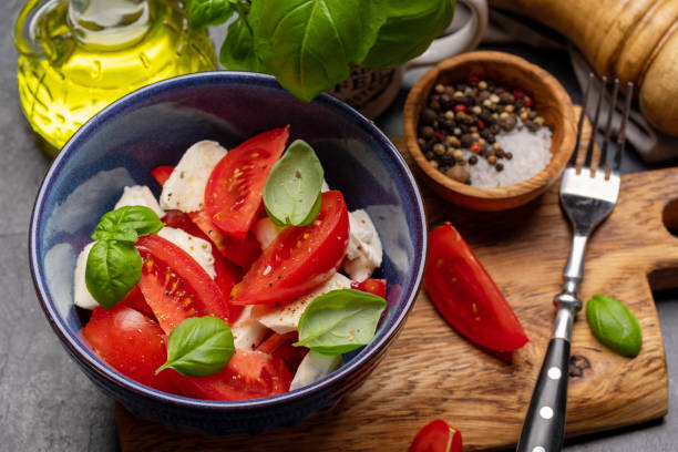 istock Caprese salad with ripe tomatoes, mozzarella and garden basil 1461077530