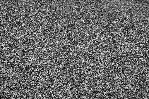 Background from small gravels, top view. Gray construction gravel texture for a poster, calendar, post, screensaver, wallpaper, postcard, banner, cover, website. Toned high quality photography