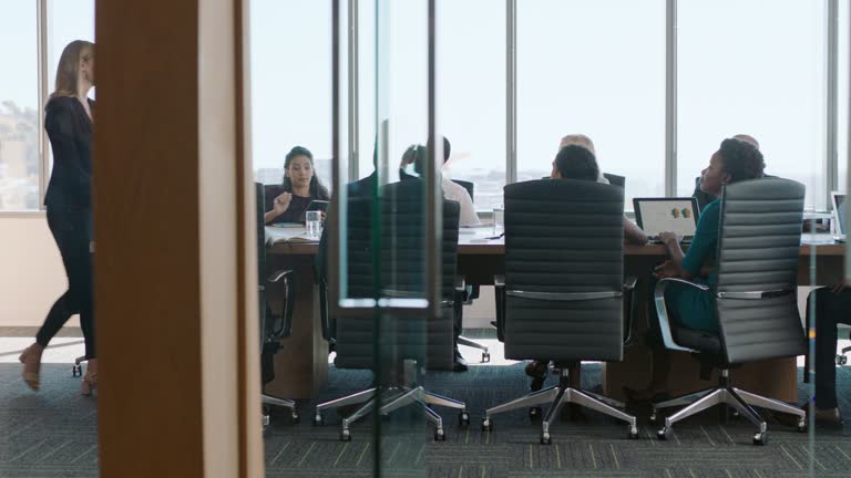 business woman team leader meeting with colleagues in boardroom discussing ideas planning strategy