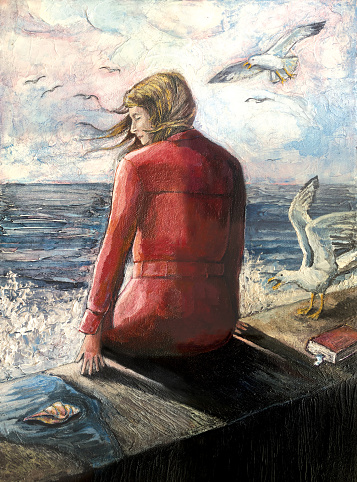 Woman sitting  next to rough sea waves.