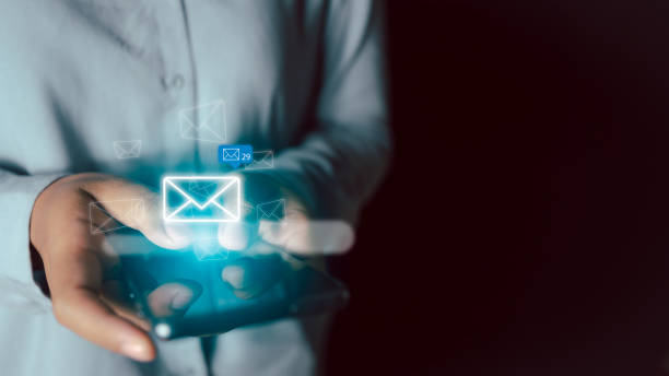 istock Businesswoman hands using smartphone typing on screen and surfing the internet on office table with email icon, email marketing concept, send e-mail or news letter, online working internet network. 1461087545