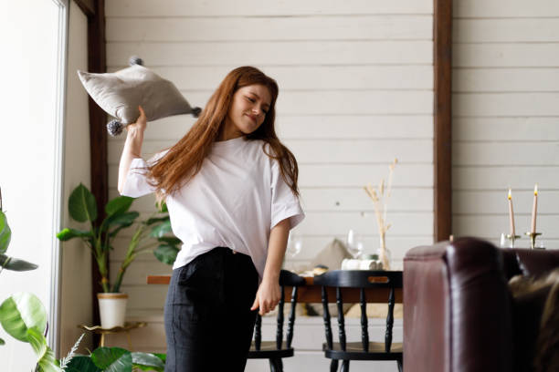 istock An angry young girl throws a pillow, difficulties in marital relations. 1461087597