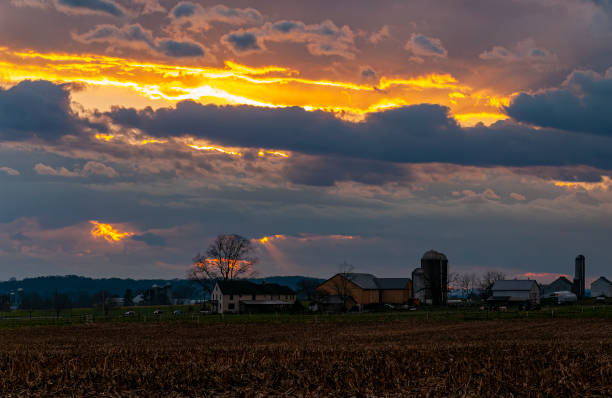 istock View of a Sunset, Trying to Break Thru Clouds, With Multiple Cloud Layers, and Red Sun 1461088204