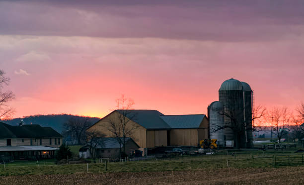 istock View of a Sunset, Trying to Break Thru Clouds, With Multiple Cloud Layers, and Red Sun 1461088250