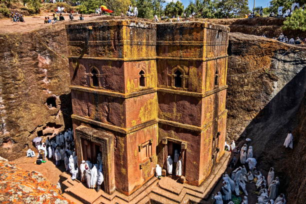 Pilgrims dressed in white, gathered for Christmas church services at the famous Rock-Hewn Church of Saint George (Biete Ghiorgis), Lalibela, Ethiopia stock photo