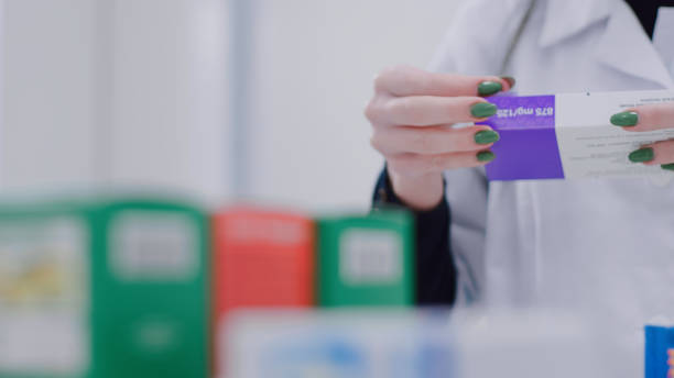 istock Pharmacist puts price tags on medicines 1461091787
