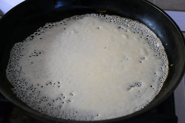 istock Cooking a delicious fried pancake in a pan. View from above 1461093484