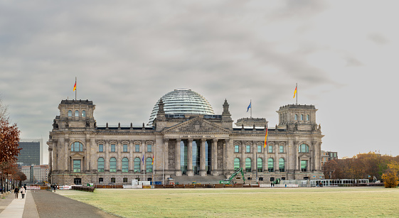 On November 19th 2022, the Bundestag, the famous federal government building in Berlin in c old  and cloudy autumn morning. This famous place is headquarters for the Federal German Government. The parliament has its sits inside the building covered by the large dome.