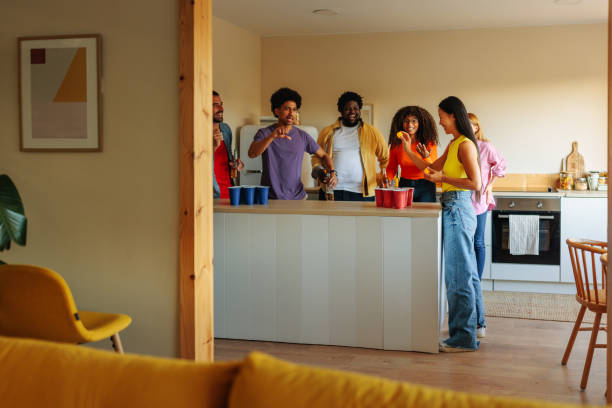 istock People playing beer pong at house party. 1461094813