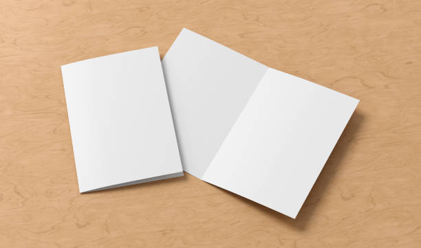 istock Half-folded flyer A4 booklet mock up on wooden background 1461096826