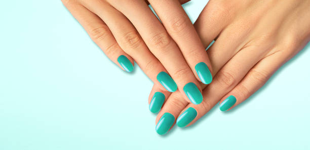 istock Beautiful groomed woman's hands with light blue nails 1461098864
