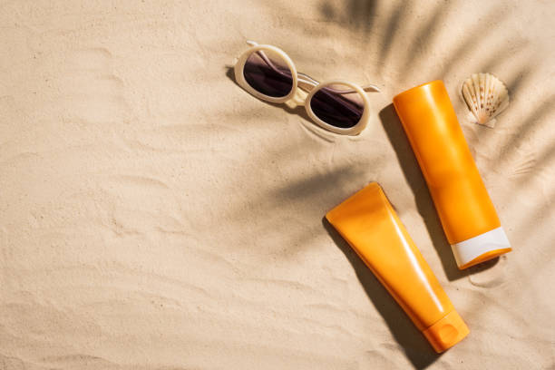 istock Sunblock lotion bottles on sandy beach 1461099670