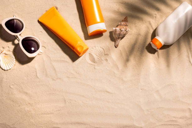 istock Sunblock lotion bottles on sand 1461099914