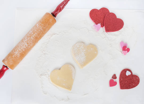 istock Valentine Holiday Heart-shaped Cookie on Floured White Background 1461103963