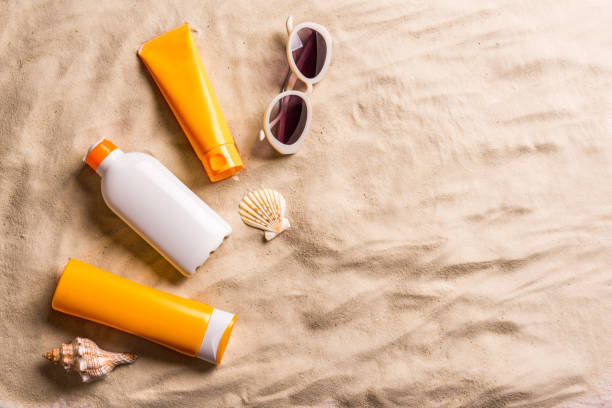 istock Sunblock lotion bottles on sand 1461104013