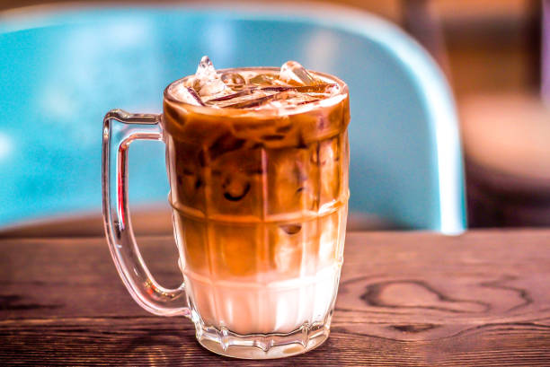 istock ice latte coffee in a glass with cream on bottom . cold summer drink background 1461104086