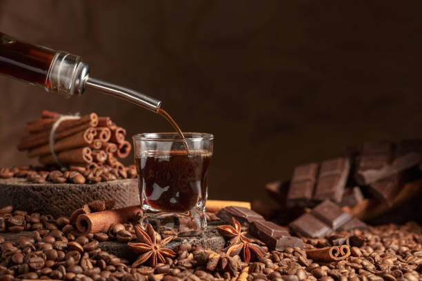 istock Coffee liquor is poured from a bottle into a glass. 1461104110