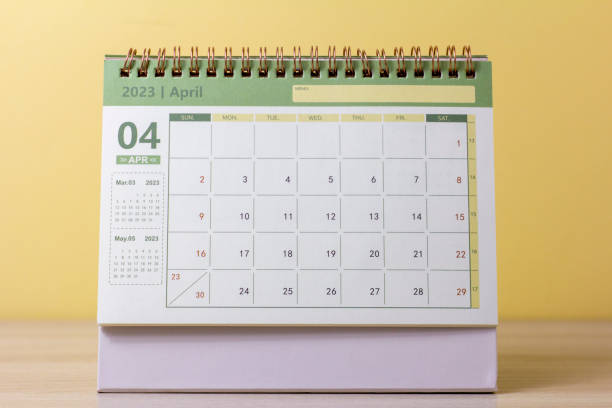 istock Hello April.Desktop calendar for April 2023 on the table. 1461106081