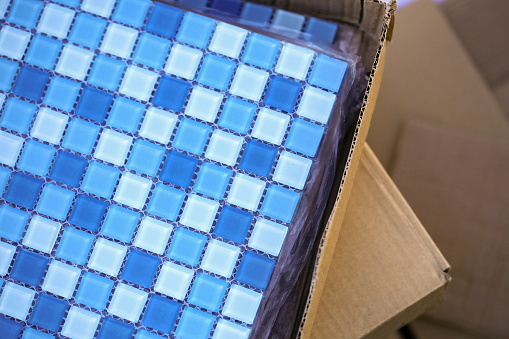 Blue mosaic tiles on a swimming pool in construction.