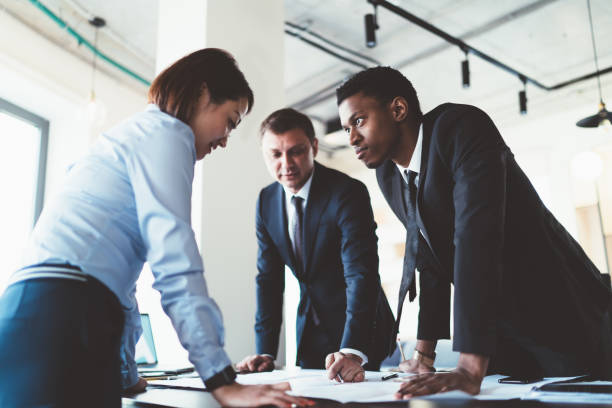 istock Businesspeople exchange views on project plan in company office 1461109554