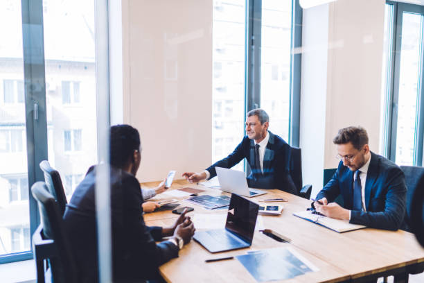 istock Group of people in classic clothes at office with devices 1461109632