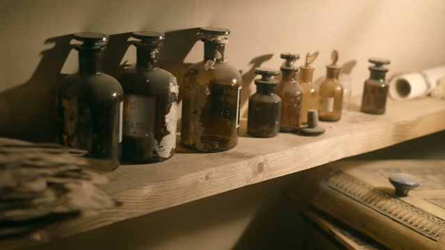 There are a lot of old-fashioned bottles with chemical or medical preparations
