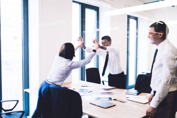 istock Cheerful businesspeople giving five in office 1461109714