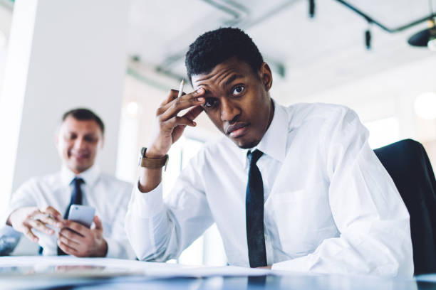 istock Tired African American man office employee having deadline 1461109736
