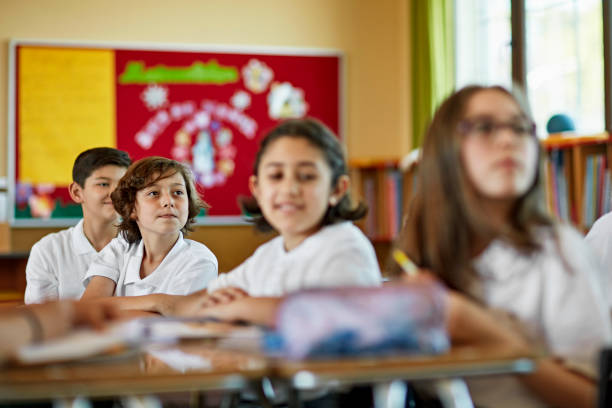 istock School children paying attention in class 1461113909