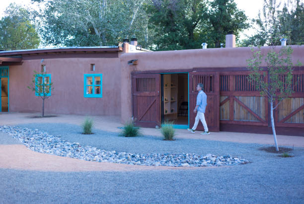 Taos, NM: A tourist at the historic Stables Art Gallery in downtown Taos; the building is part of the original Arthur Manby compound, next to The Taos Inn.