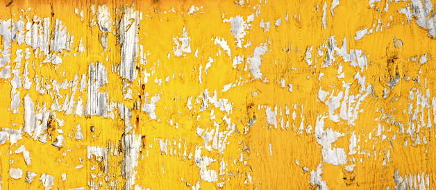 Background image of close up peeled orange color textured wooden building exterior surface