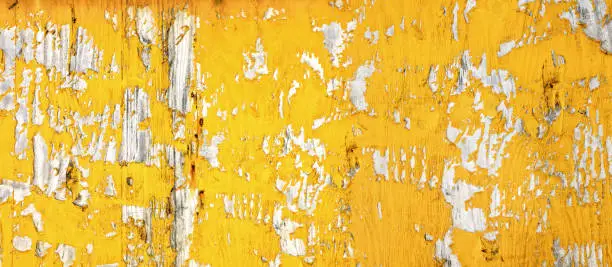 Photo of Peeled yellow painted wooden wall texture