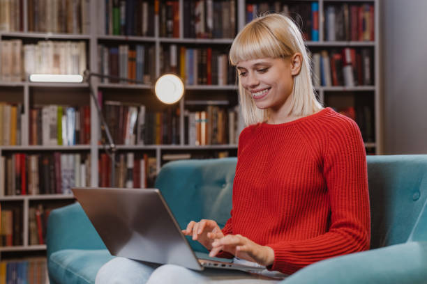 istock Female student using laptop in the library 1461118179