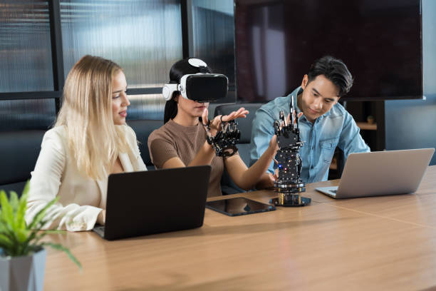 istock Male and female engineer working with vr glasses control AI robot arm system in workshop. Male engineer using laptop computer for training Programmable logic controller robotics arm system project 1461118215