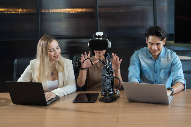 istock Male and female engineer working with vr glasses control AI robot arm system in workshop. Male engineer using laptop computer for training Programmable logic controller robotics arm system project 1461118245
