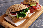 Sandwich with camembert and lettuce leaves and cranberries