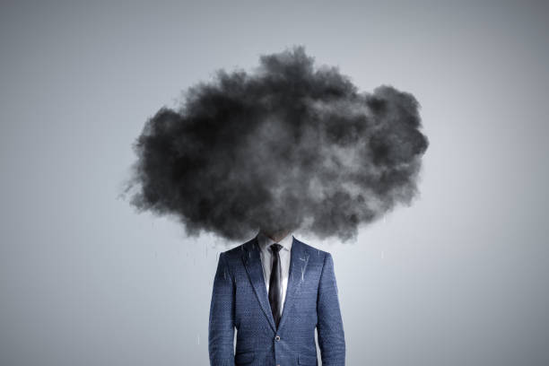 Person with a dark cloud over the head Man in a suit with a dark cloud over the head. Isolated on a neutral background. hopelessness stock pictures, royalty-free photos & images
