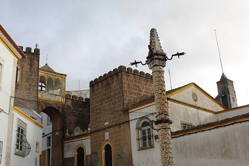 Elvas, Portugal – December 8, 2022: Pillory and gate to the old Arab fortress in Elvas, Portugal.