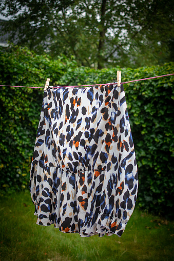 Wild animal pattern blouse drying on coateline