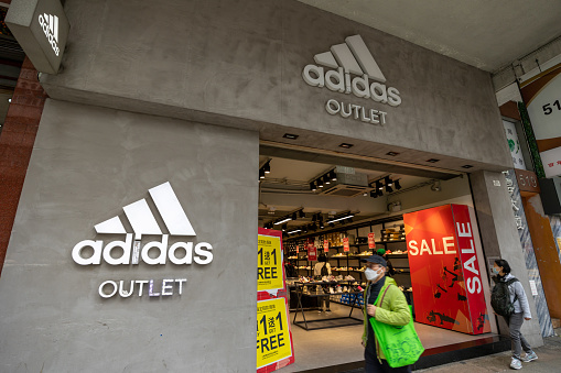 Hong Kong - January 31, 2023 : People walk past the Adidas outlet in Hong Kong. It is a famous sportswear company.