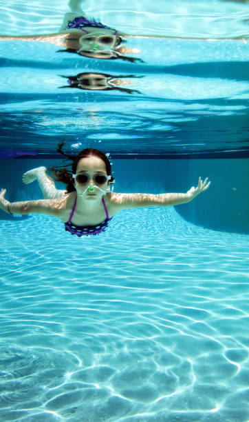 istock Little girl underwater swimming pool fun 1461125584