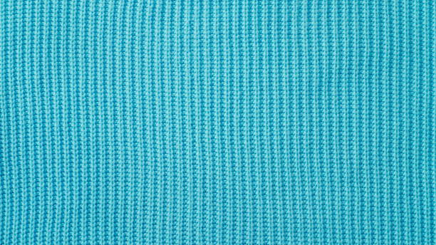 Texture of a knitted woolen fabric. Blue color. Background